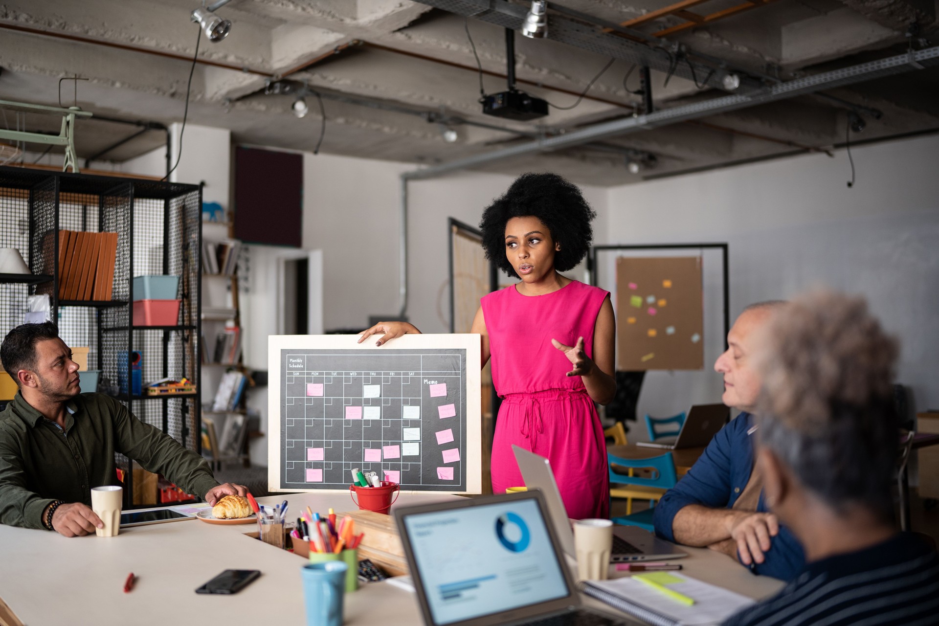Young woman talking in a meeting at work - including a transgender person